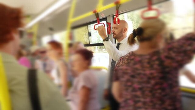 Businessman commuting to work on a crowded public bus