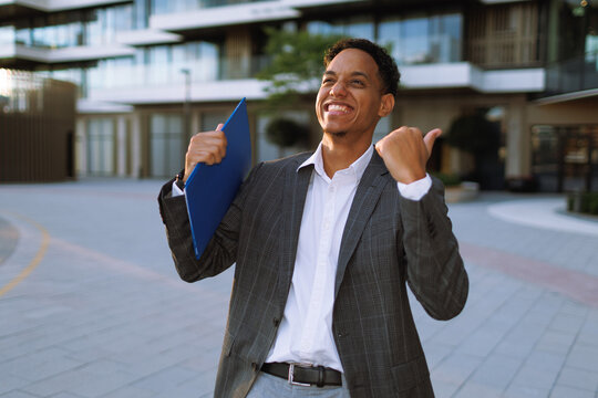 Young businessman celebrating success, career achievement and promotion