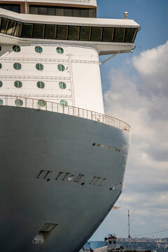 Close up view of massive cruise ship bow moored in sea port. Maritime navigation and luxury travel concept.