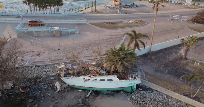 Natural disaster aftermath. Destroyed yachts after hurricane Milton on Manasota Key in Englewood, Florida.
