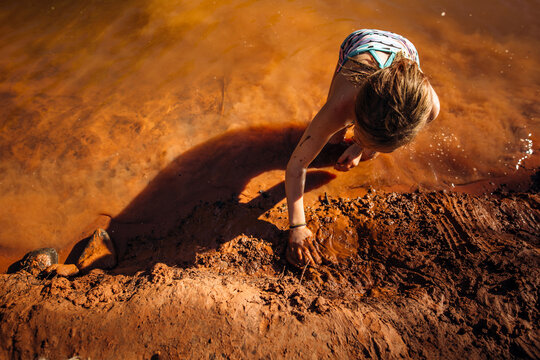 Young Girl Playing in the Mud