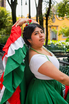 Mexican folkloric dancer holding skirt over head outdoors