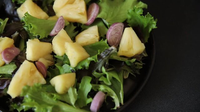 Pineapple salad mixed green salad leaves and pineapple chunks food preparation tasty snack fresh gourmet food background on the table rustic food top view 