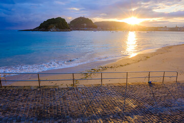 Naklejka premium Ondarreta Beach and La Concha Bay at Sunrise in San Sebastian, Basque Country, Spain