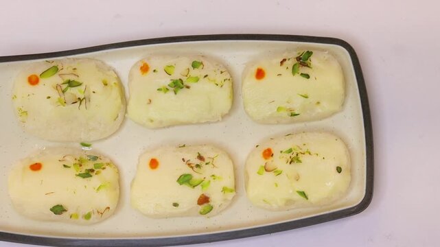Malai cham cham sweet beautifully placed on white background 