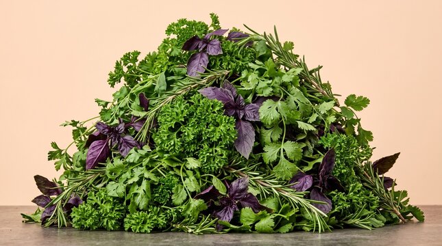 Large pile of fresh green and purple aromatic culinary herbs on a dark surface.