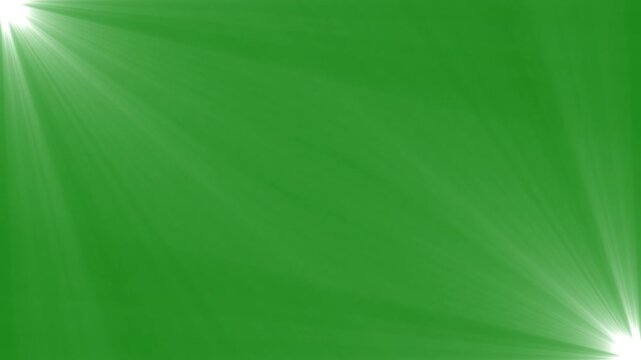 Diagonal dual optical spotlight flare overlay with glowing light rays on solid green screen background.