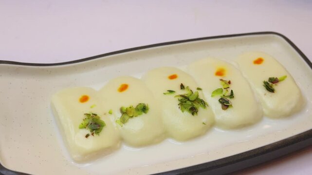 Malai cham cham sweet beautifully placed on white background 