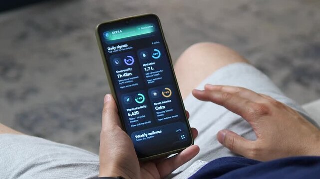 Person reviews a mobile wellness dashboard tracking sleep, hydration, activity and stress, reflecting the growing trend of data-driven self-care and everyday health monitoring.