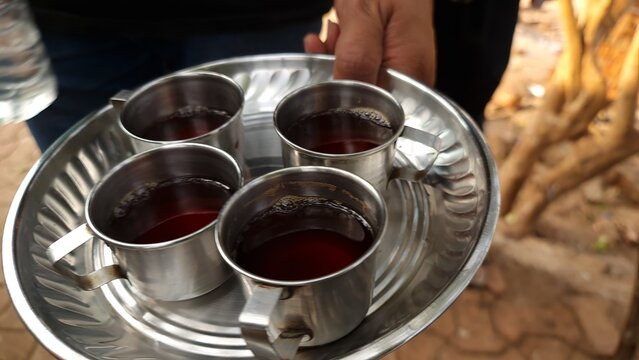 Four Cups of Indian Tea Served on a Stainless Steel Tray at an Outdoor Refreshment Stall