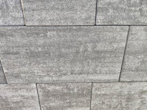 Top down close up of grey interlocking concrete driveway paving stones
