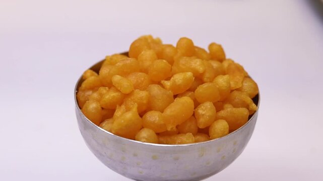 Boondi or nukti in a silver cup on white background 