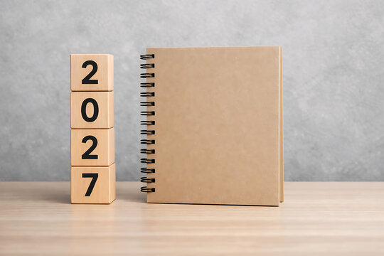 2027 Calendar Concept with Wooden Blocks and Notebook