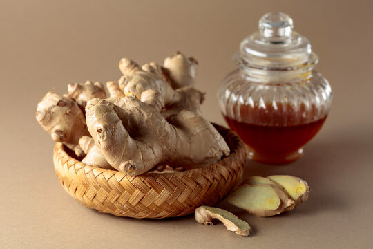 Ginger with honey jar on a beige background.