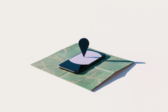 Smartphone on a folded paper street map with a floating location pin, featuring a blank screen mockup and clean shadows for location services and app design