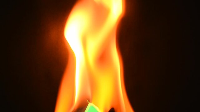 Burning black piece of paper and revealing green screen background
