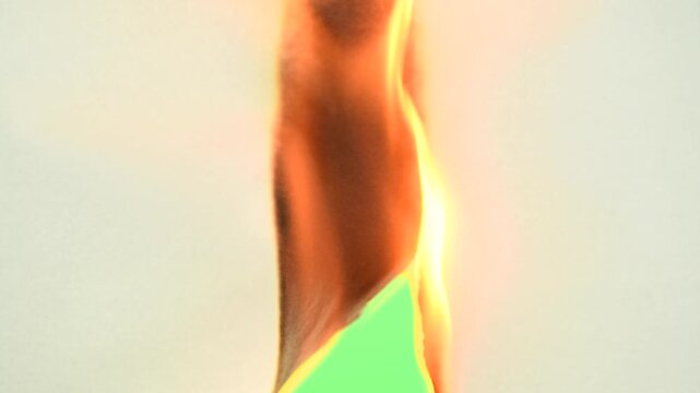 Burning piece of paper on green screen background