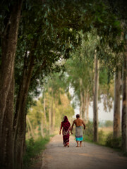 Fototapeta premium A timeless walk of love, companionship, and simple rural beauty