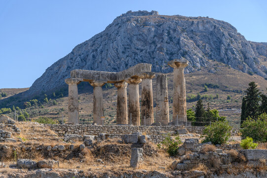 Seven Doric columns of the Temple of Apollo standing before the rock of Acrocorinth, Ancient Corinth, Greece