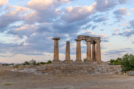 Doric columns of the Temple of Apollo silhouetted against a pastel dusk sky, Ancient Corinth, Greece