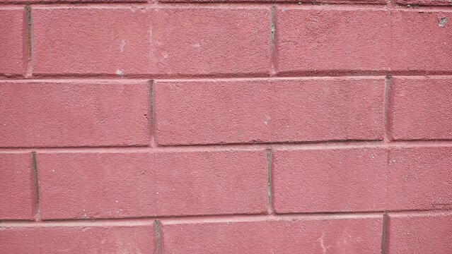 Weathered red brick wall texture with visible mortar and natural finish