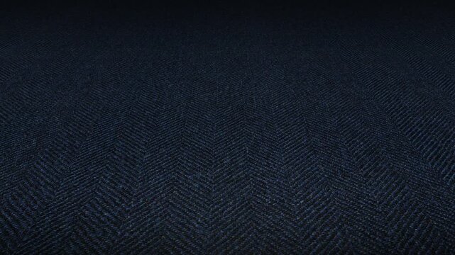 Detailed diagonal slider movement across Italian navy blue herringbone fabric displaying classic woven pattern and high quality textile background material