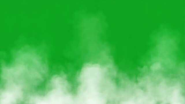 White smoke or fog effect rising from the bottom on a solid chroma green screen background for video editing and compositing