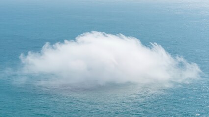 Fototapeta premium Ethereal White Cloud Formations Floating Low Over the Calm Blue Ocean Surface, Atmospheric Mist and Foggy Phenomenon in the Open Sea under Bright Natural Sunlight, Abstract Nature View
