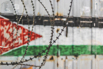Palestinian flag mural behind barbed wire © nayefhammouri