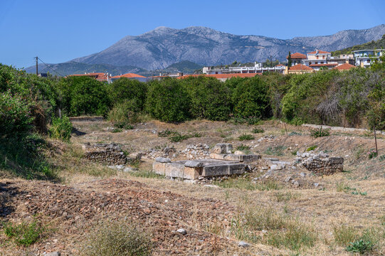 Ancient stone tomb with its heavy cover slab in an excavated plot below the village, Ancient Epidaurus, Greece