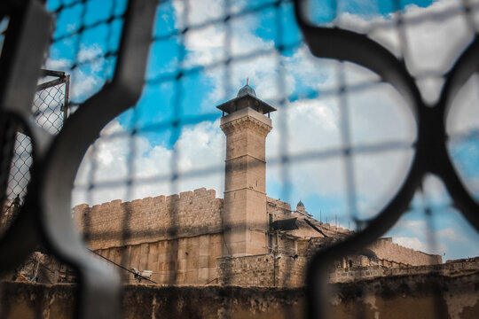 Ibrahimi Mosque minaret viewed through security fence