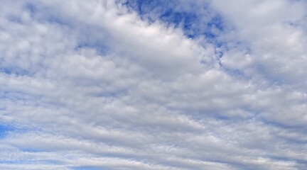 Obraz premium White fluffy clouds in the blue sky.