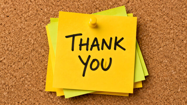 Yellow thank you sticky notes arranged on a corkboard expressing gratitude appreciation customer feedback recognition workplace communication and positive messaging
