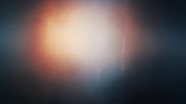 abstract backdrop featuring a textured surface with a flare gradient from warm orange light to deep cool blue tones