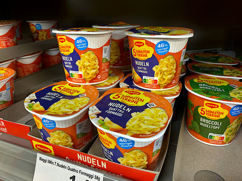 BERLIN, GERMANY - AUGUST 23, 2026: Maggi 5 Minuten Terrine Instant Noodle Cups on Supermarket Shelf