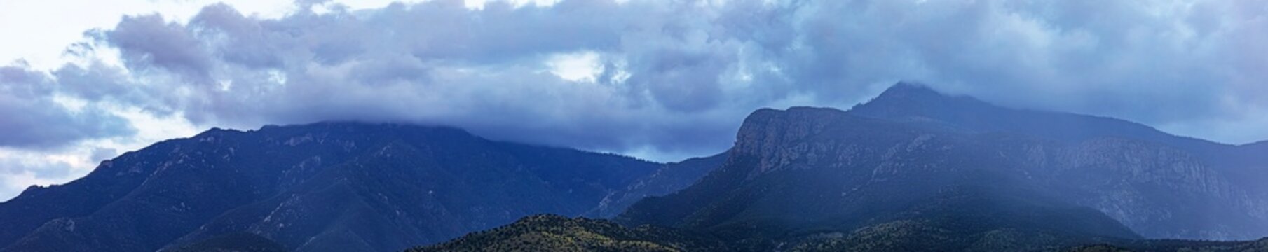 Panoramic view of a monsoon rain storm over Arizona's Huachuca Mountains