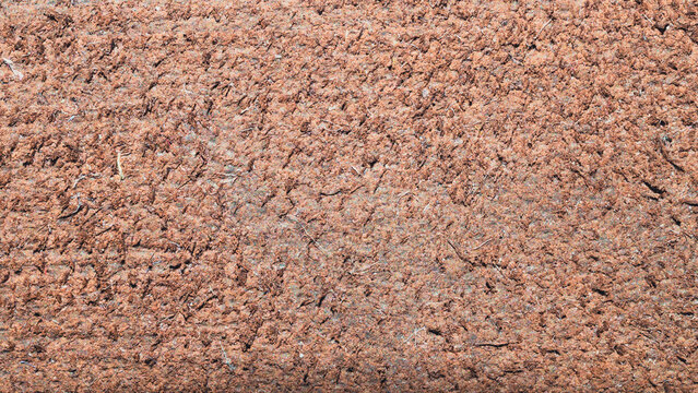 Macro texture of rough brown cardboard with pressed wood fibers