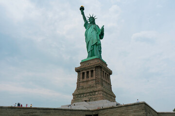 Close view looking up at the Statue of Liberty with the base visible in July 2026 © R Macouzet