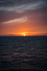 Fototapeta premium Sunset Viewed from a Cruise Ship Sailing Across the North Atlantic with Warm Reflections Along the Deck, August 2026