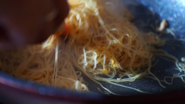 Close-up of Stir-fried Rice Vermicelli Noodles (Bihon) Being Cooked in a Hot Pan with Steam