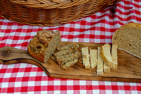 Healthy wholegrain wheat and rye bread pieces cut on a wooden board 