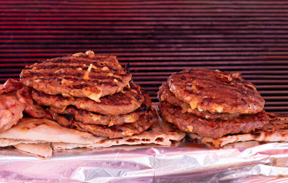 Stack of grilled beaf meat hamburgers covered with melted cheese