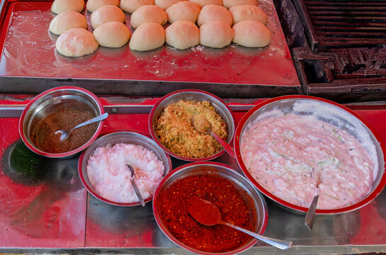 Food condiments spices inside metal bowls served outside on market