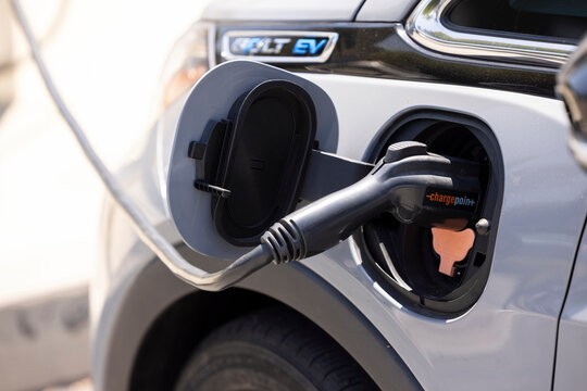 Fullerton, California, USA - August 22, 2026: A Chevrolet Electric Bolt EV charges at a Charge Point station.