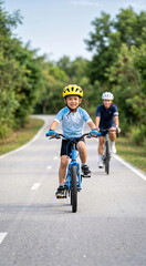Fototapeta premium Vertical photo of a young Asian boy riding a blue bicycle. Child wearing a yellow helmet training on a paved path with his mother. Active family outdoor recreation