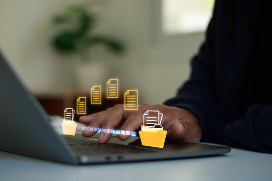 Business professional managing digital files and documents transfer on laptop, illustrating cloud storage, document management, data organization, workflow automation, and secure file access for work.