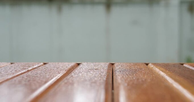 Empty wooden tabletop with blurred neutral grey copy space background