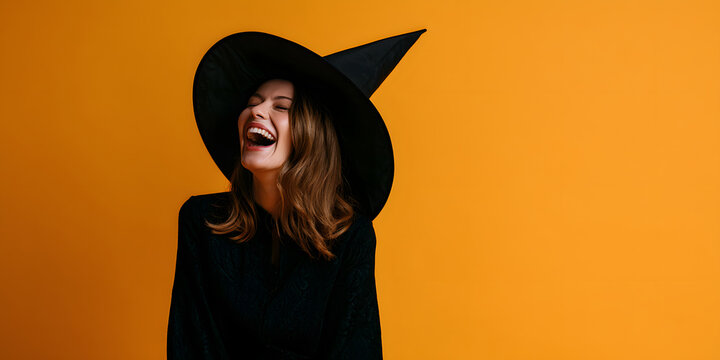 A joyful adult lady in a witches costume is chuckling on an orange banner with room for additional information