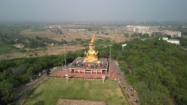Drone orbit from front to right of golden Hanuman statue Indore