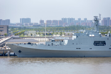 Chinese warship at a riverside berth on the Yangtze near Shanghai, representing China's naval capabilities and maritime security. © Mariusz